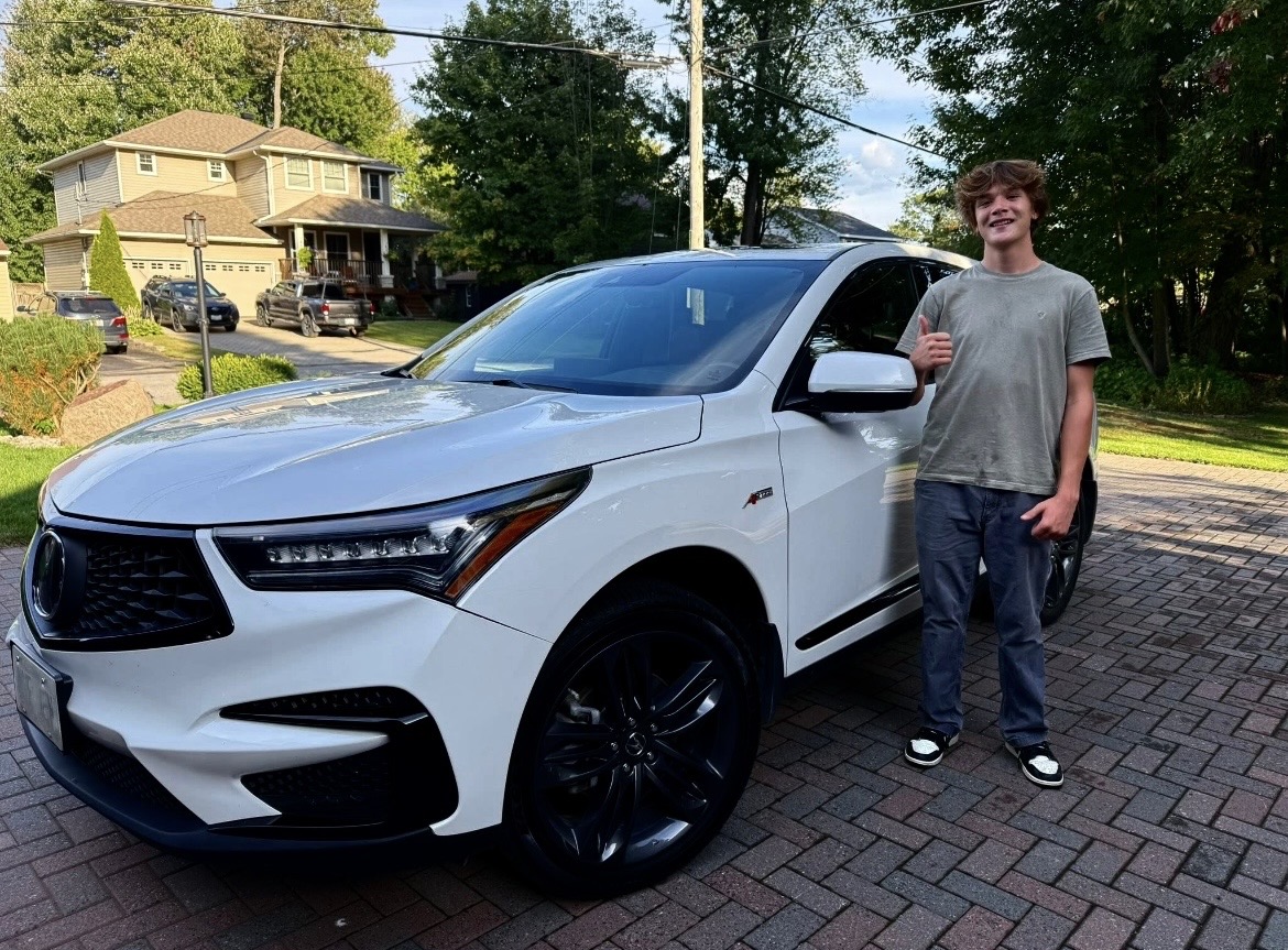 Jack Collins, owner of Driveway Auto Spa, with a freshly detailed Acura